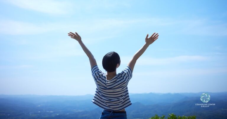 Someone with their arms up embracing new therapy