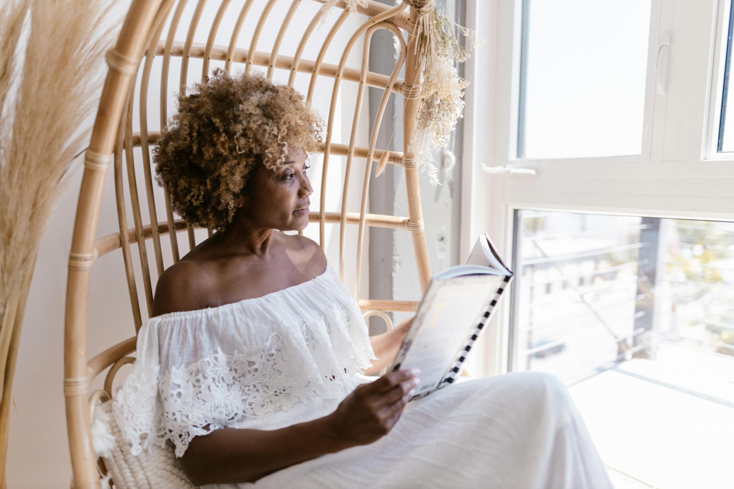 Woman sitting by window reclaiming peace after narcissist